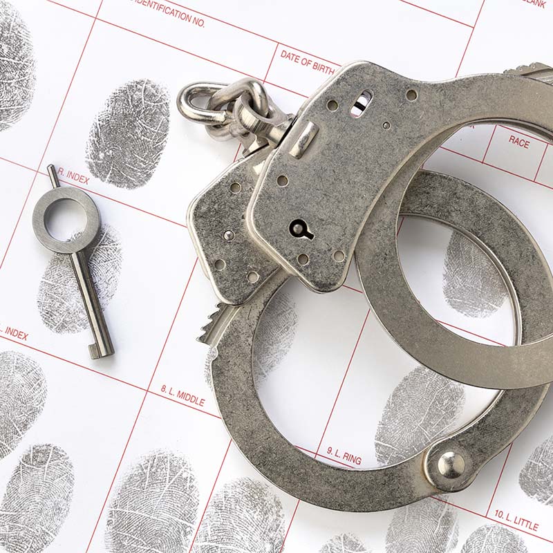 handcuffs-on-fingerprint-sheet-549WZVG.jpg